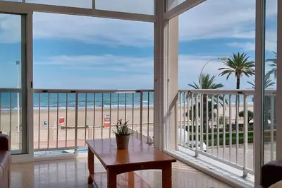 a living room with a view of the beach at Santa Marta frente al mar in Cullera