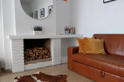 a living room with a couch and a fire place at Santa Marta frente al mar in Cullera