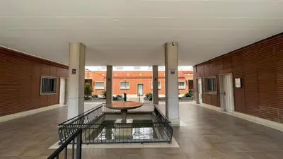 an empty hallway with a table in the middle of a building at flat family near center and jardin turia avenida del cid in Valencia