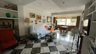 a living room with a couch and a checkered floor at flat family near center and jardin turia avenida del cid in Valencia