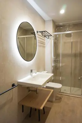 a bathroom with a sink and a toilet and a mirror at Lumen Mare by SH Hoteles in Valencia