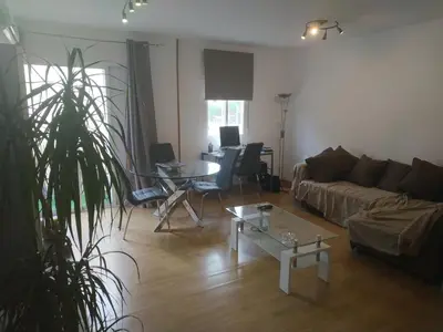a living room with a couch and a table at Bedroom to rent in the beach in Valencia