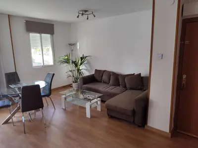 a living room with a couch and a table at Bedroom to rent in the beach in Valencia