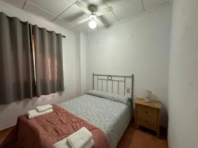 a bedroom with a bed and a ceiling fan at Casa El Calderon in Chella