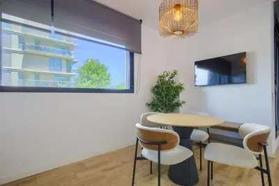 a dining room with a table and chairs and a window at Arena 20 Suites in Valencia