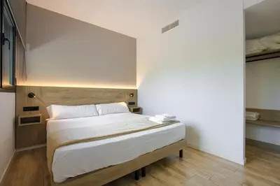 a bedroom with a large bed with white sheets at Arena 20 Suites in Valencia