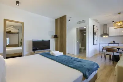 a hotel room with a large bed and a bathroom at Arena 20 Suites in Valencia