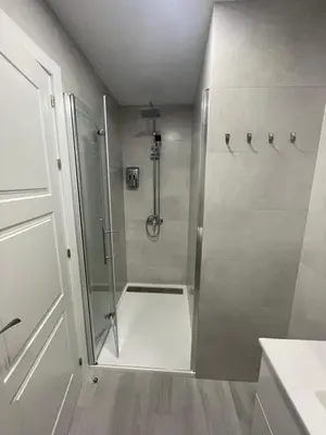 a shower with a glass door in a bathroom at Apartamento de lujo en Cullera con Aire Acondicionado in Cullera