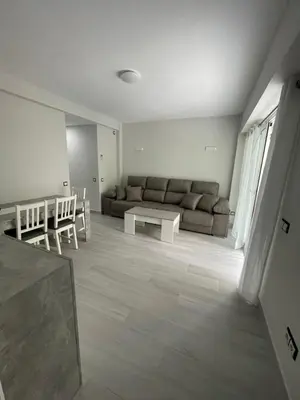 a living room with a couch and a table at Apartamento de lujo en Cullera con Aire Acondicionado in Cullera