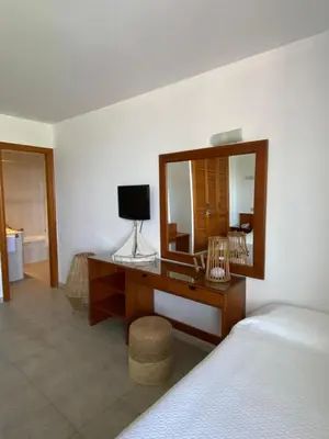 a bedroom with a desk with a mirror and a bed at Hostal Blayet - Hostal Automatizado in Valencia