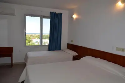 a hotel room with two beds and a window at Hostal Blayet - Hostal Automatizado in Valencia