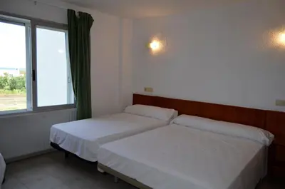 a bedroom with two beds and a window at Hostal Blayet - Hostal Automatizado in Valencia