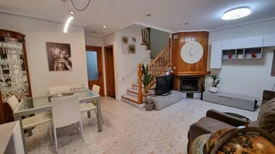 a living room with a fireplace and a staircase at Bali Beach Puzol relax en la playa cerca de Sagunto y Valencia in Puzol