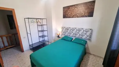 a room with a blue couch in a room at Bali Beach Puzol relax en la playa cerca de Sagunto y Valencia in Puzol