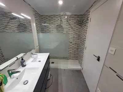 a bathroom with a sink and a mirror and a shower at Precioso apartamento reformado con terraza, 4 habs in Valencia