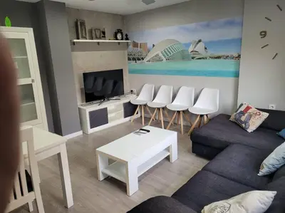 a living room with a couch and a table at Precioso apartamento reformado con terraza, 4 habs in Valencia