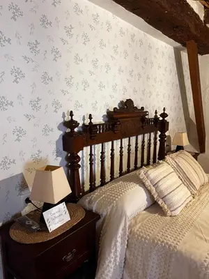 a bedroom with a bed and a table with a lamp at Casa rural La Boticaria in Villar del Arzobispo