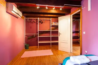 a room with a closet with purple walls and a bed at Attic Duplex Ruzafa in Valencia