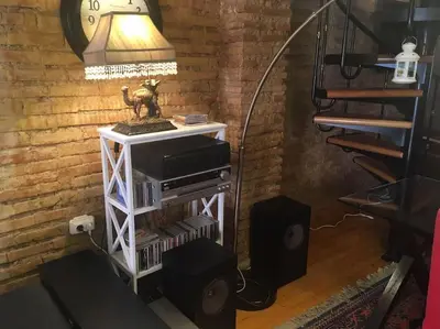a room with a table with a lamp and speakers at Attic Duplex Ruzafa in Valencia