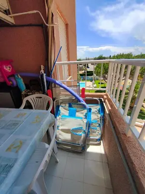 a balcony with a table and chairs on a balcony at Mar i piscina Canet playa in Canet de Berenguer