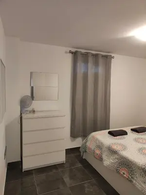 a bedroom with a bed and a dresser and a window at Mar i piscina Canet playa in Canet de Berenguer