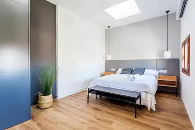 a bedroom with a bed and a large mirror at Puerto Beach suites in Valencia