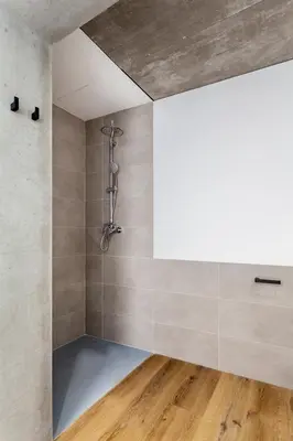 a shower in a bathroom with wooden floors at Puerto Beach suites in Valencia