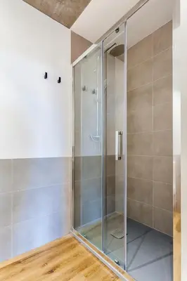 a shower in a bathroom with a glass door at Puerto Beach suites in Valencia