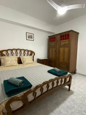 a bedroom with a bed with blue towels on it at Beautiful apartment 1 minute walk to the beach in Puerto de Sagunto