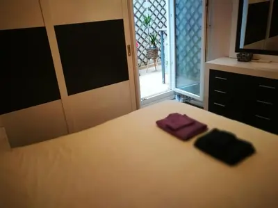 a bedroom with a bed with two towels on it at City center where Falla starts in Valencia