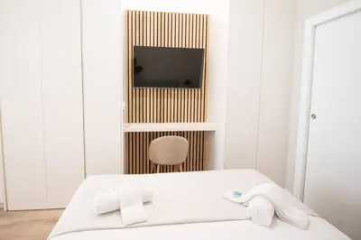 a bedroom with a bed and a tv and a chair at Maritim 2 by Concept Flats in Valencia