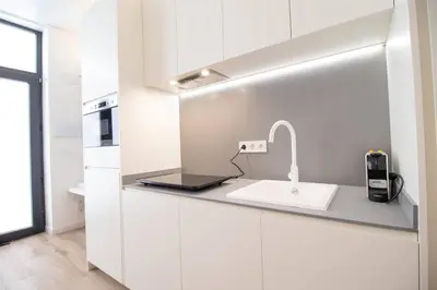 a kitchen with white cabinets and a sink at Maritim 2 by Concept Flats in Valencia