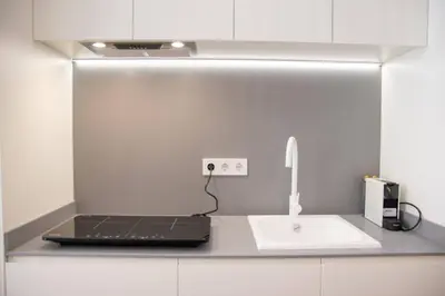 a kitchen counter with a laptop and a sink at Maritim 2 by Concept Flats in Valencia