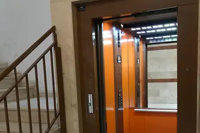 an orange door in a building with a staircase at Apartamento cómodo y espacioso con parking in Valencia
