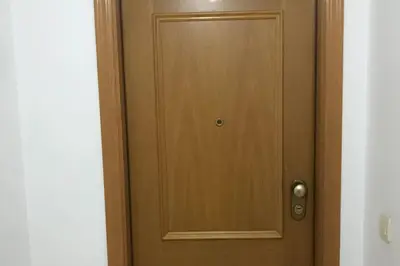 a wooden door in a room with at Apartamento cómodo y espacioso con parking in Valencia