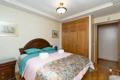 a bedroom with a large bed with blue pillows at GuestReady - A un paso del Mediterráneo in El Puig