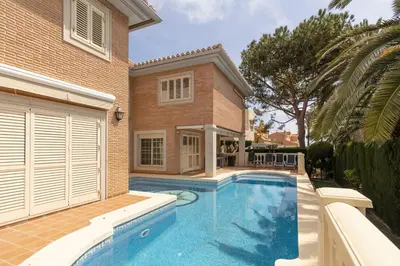 a swimming pool in front of a house at GuestReady - A un paso del Mediterráneo in El Puig