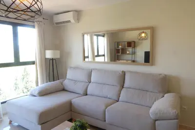 a hallway with white walls and a black door at Precioso apartamento en Canet Playa by Hometels in Canet de Berenguer