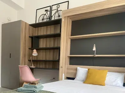 a bedroom with a bed with a bike above it at Habitación en Playa Malvarrosa con baño privado -No AC- in Valencia