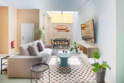 a living room with a couch and a table at Habitación en Playa Malvarrosa con baño privado -No AC- in Valencia