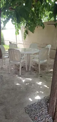 a white table and four chairs under a tree at LA TRAMUNTANA CULLERA Playa Marenyet a 300 metros in Valencia