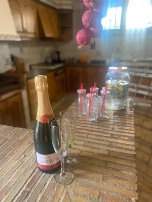 a bottle of champagne and two wine glasses on a table at Casa Ellenita in Las Canteras