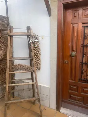 a wooden ladder leaning against a wall next to a door at Casa Ellenita in Las Canteras