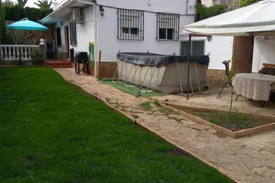 a garden with a tub in the yard of a house at Casa Tena in Partida de La Cañada