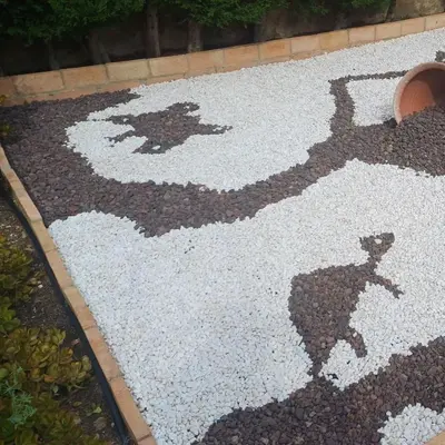 a teddy bear painted on the ground in a garden at Casa Tena in Partida de La Cañada