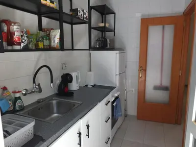 a kitchen with a sink and a counter top at Neptuno Playa San Antonio in Cullera