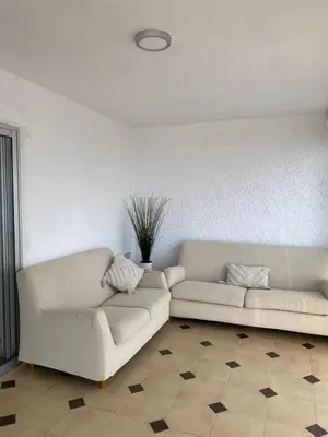 a living room with two white couches at Cara al mar in Cullera