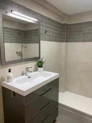 a bathroom with a sink and a mirror and a tub at Cara al mar in Cullera