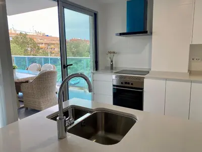 a kitchen with a sink and a window with a view at VoraMar 3 Playa Puerto de Sagunto in Sagunto