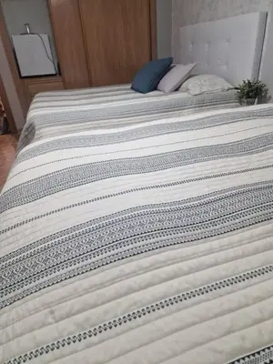 two beds with white sheets on top of each other at Habitaciones Zoe in Puerto de Sagunto